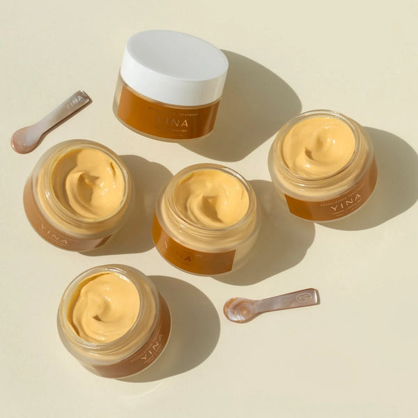 Five jars of Yina cream on a beige background