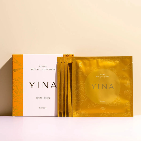 YINA Divine Bio-Cellulose Mask packaging, showing a white and orange outer box alongside five individual gold foil mask packets on a clean beige background.