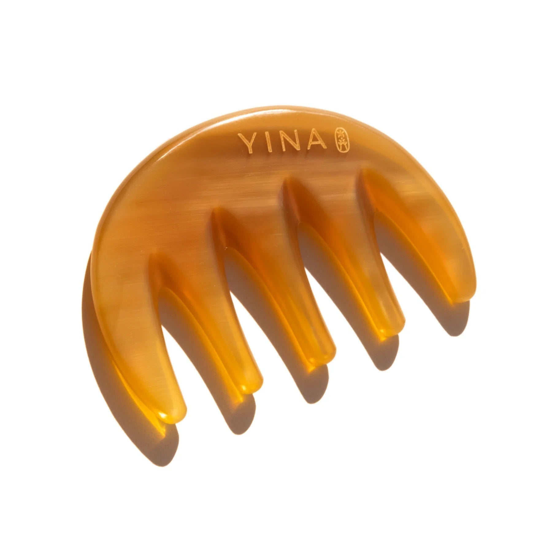 YINA Meridian Massage Comb - luxurious haircare tool inspired by ancient East Asian wellness rituals. Hand-crafted from sustainable natural buffalo horn with a rounded, wide-tooth design for gentle detangling and scalp massage. Promotes hair health and scalp vitality with regular use.