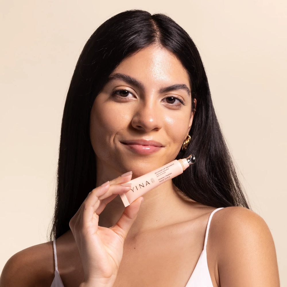 YINA Recovery Lip Balm in a sleek tube, featuring hydrating ingredients like ginseng, peptides, and shea butter for smooth, soft lips.