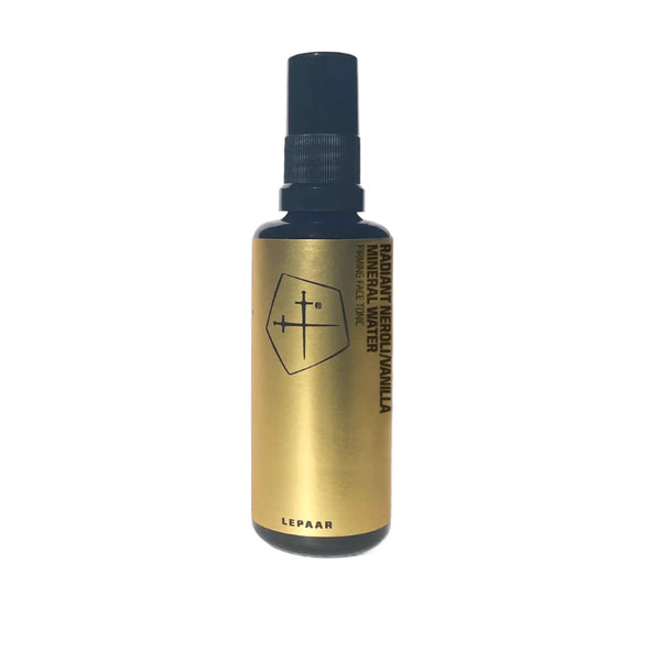 A 50ml amber glass spray bottle of LEPAAR Radiant Neroli/Vanilla Mineral Water, featuring a minimalist design with a geometric emblem and a black spray nozzle, set against a white background.